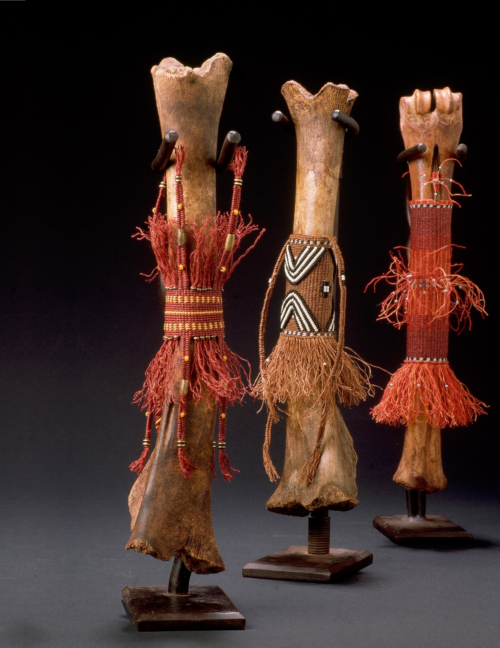 Bone Dancers — three bone sculptures with beaded wraps and fiber embellishments