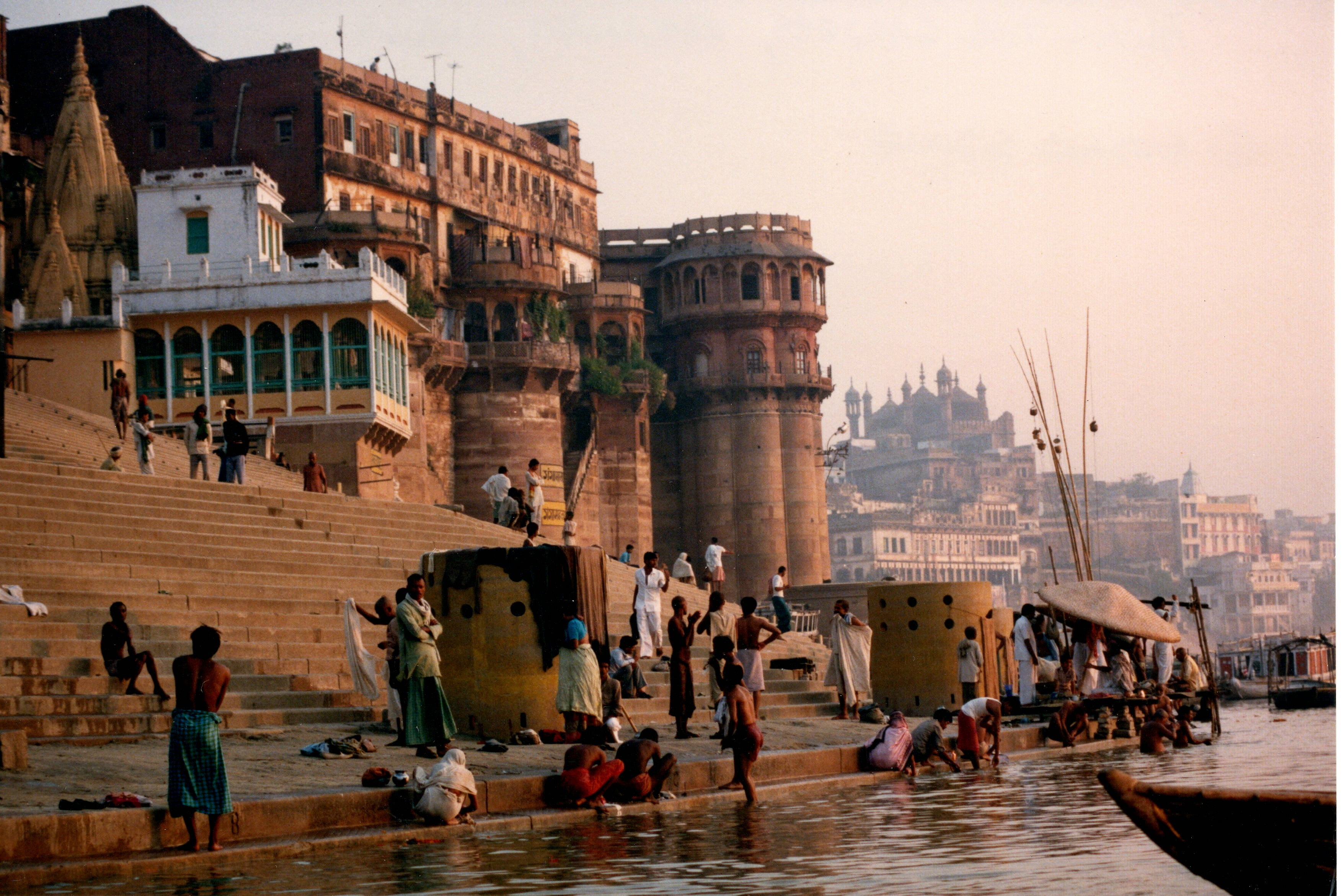 Morning on the ghats of Varanasi — pilgrims, boats, and ancient temple towers rising from the Ganges